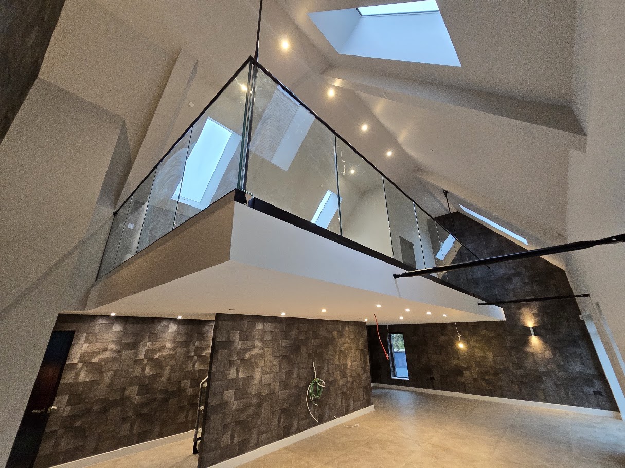 Frameless glass mezzanine in a vaulted home — Manchester Balustrades installation